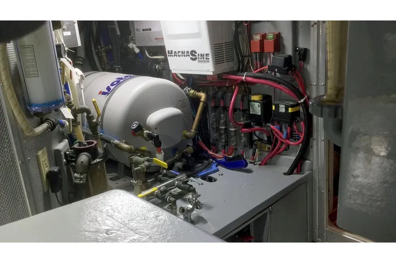 Slide: The Image of Engine room of 2001 Nordhavn 46 yacht with complex machinery and wiring. - 52