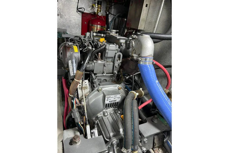 Slide: The Image of Engine compartment of a 2001 Nordhavn 46 yacht, featuring detailed mechanical components. - 59