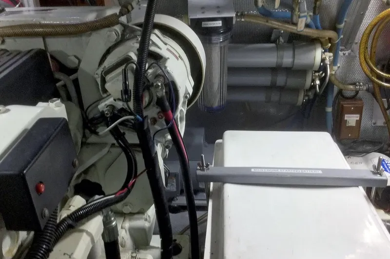 Slide: The Image of Engine room of 2001 Nordhavn 46 yacht, showcasing mechanical components and wiring. - 60