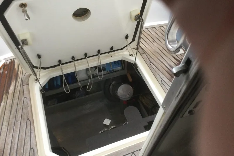 Slide: The Image of Open hatch on 2001 Nordhavn 46 yacht, revealing storage compartment and equipment. - 64