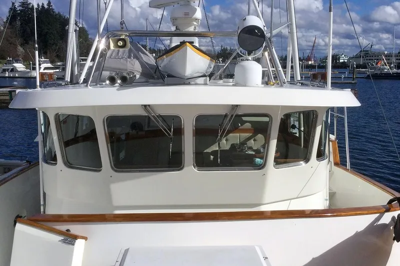 Slide: The Image of 2001 Nordhavn 46 yacht docked at marina, featuring spacious cabin and navigation equipment. - 9