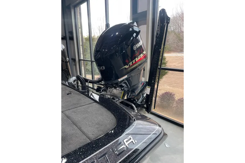 Slide: The Image of 2018 Skeeter ZX250 boat with Yamaha VMAX engine in a garage setting. - 1