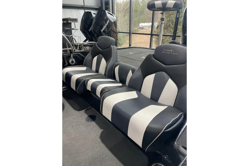 Slide: The Image of 2018 Skeeter ZX250 boat interior with gray carpet and storage compartments. - 7