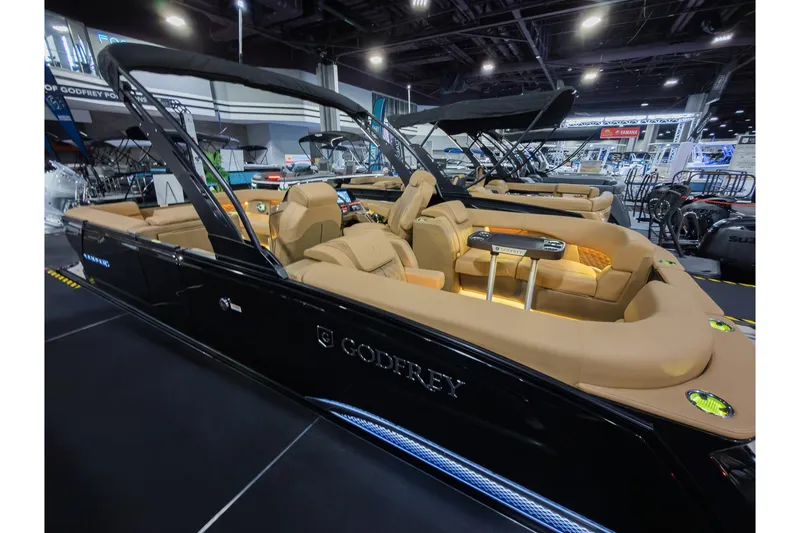 Slide: The Image of 2026 Godfrey SanPan 25' Split Bench Co-Captain pontoon boat at indoor exhibition. - 28
