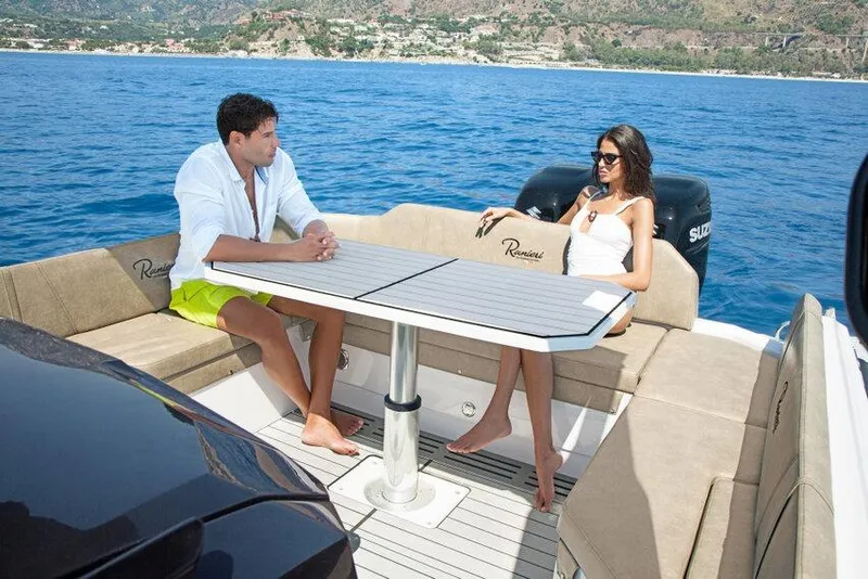 Slide: The Image of Couple relaxing on a 2026 Ranieri CAYMAN 35.0 EXECUTIVE boat in open water. - 11