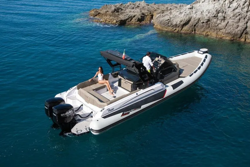 Slide: The Image of 2026 Ranieri CAYMAN 35.0 EXECUTIVE boat cruising near rocky shoreline. - 14