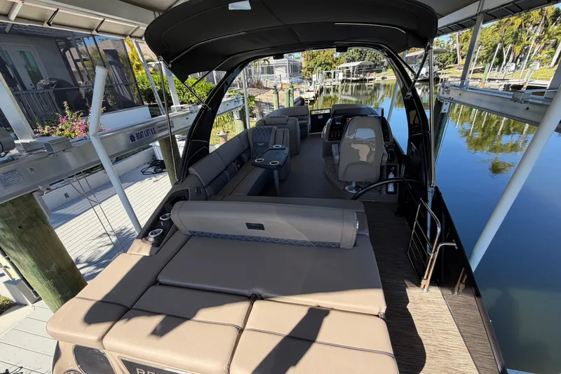 Slide: The Image of 2024 Bennington 25 QX Swingback pontoon boat with luxurious seating and sleek design. - 14