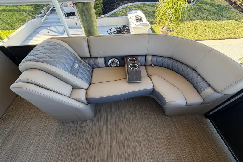 Slide: The Image of Luxurious seating on 2024 Bennington 25 QX Swingback boat with cup holders and elegant design. - 19