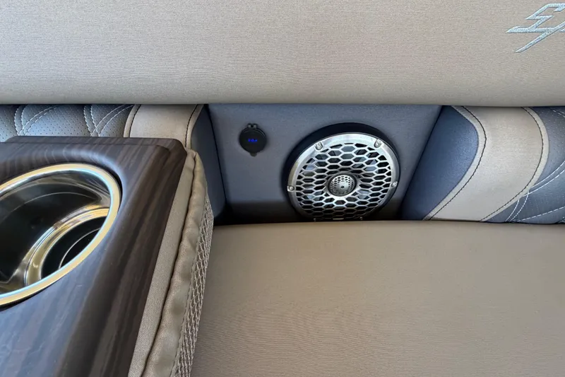 Slide: The Image of 2024 Bennington 25 QX Swingback interior with speaker and cup holder detail. - 21