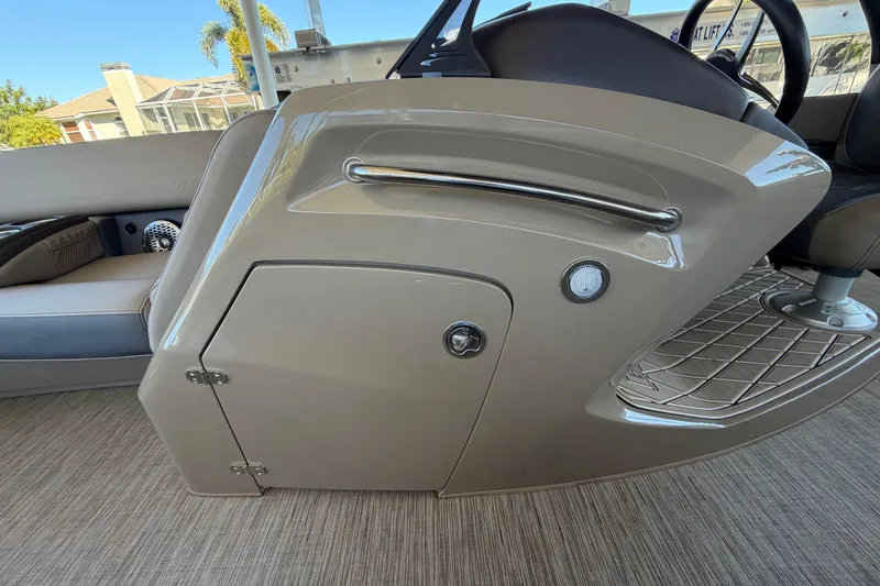 Slide: The Image of 2024 Bennington 25 QX Swingback boat interior, featuring sleek console design and seating. - 22
