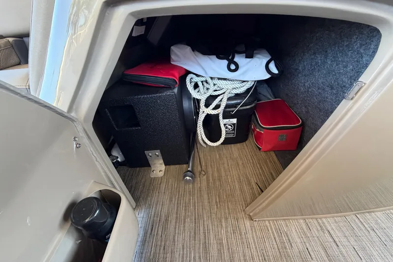 Slide: The Image of Storage compartment in 2024 Bennington 25 QX Swingback boat with ropes and equipment. - 23