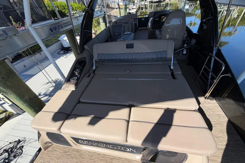 Slide: The Image of 2024 Bennington 25 QX Swingback boat interior with luxurious seating and modern design. - 27