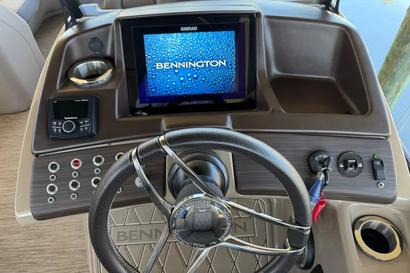 Slide: The Image of 2024 Bennington 25 QX Swingback dashboard with steering wheel and digital display. - 8
