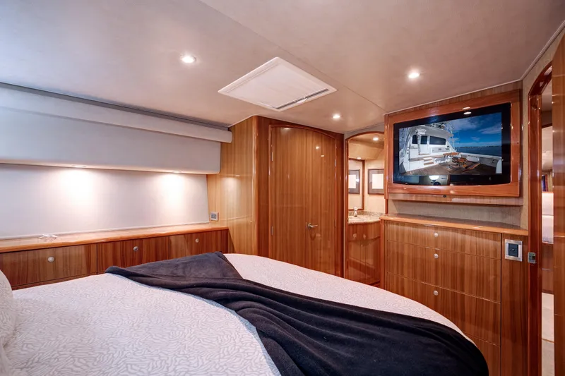 Slide: The Image of Luxurious bedroom interior of 2007 Viking 68 Convertible yacht with wood paneling and TV. - 10