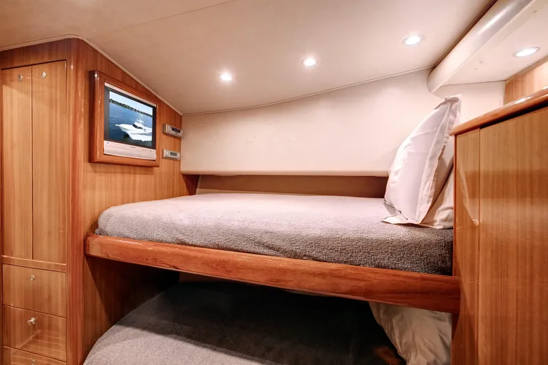 Slide: The Image of Luxurious cabin interior of 2007 Viking 68 Convertible yacht with cozy bed and TV. - 13