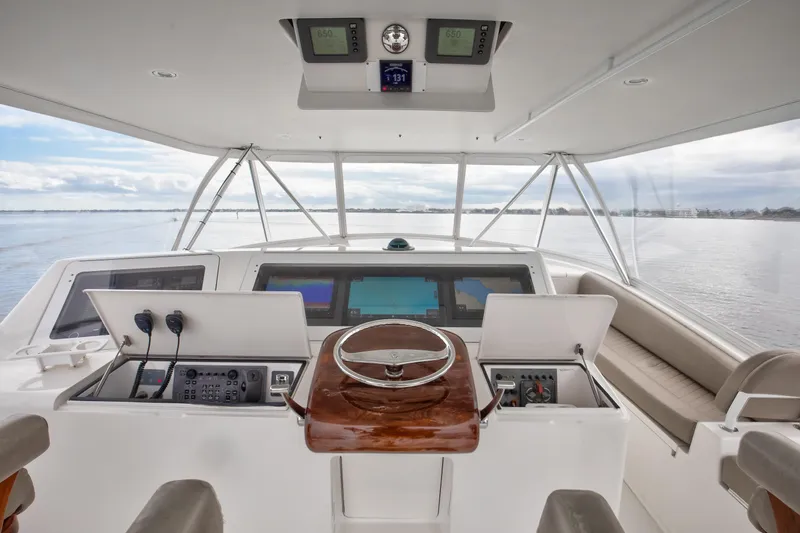 Slide: The Image of 2007 Viking 68 Convertible yacht helm with navigation equipment and panoramic water view. - 17
