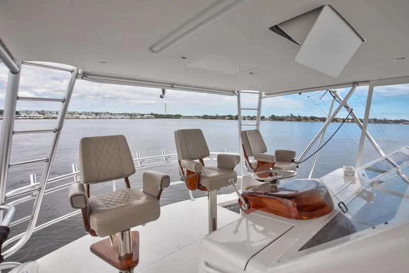 Slide: The Image of 2007 Viking 68 Convertible yacht helm with three captain chairs overlooking serene waters. - 19
