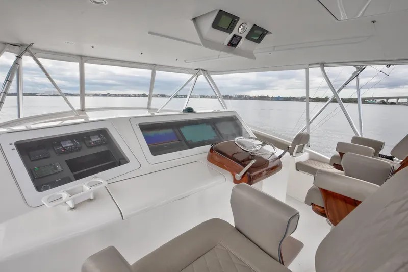 Slide: The Image of 2007 Viking 68 Convertible yacht helm with modern navigation equipment and comfortable seating. - 2