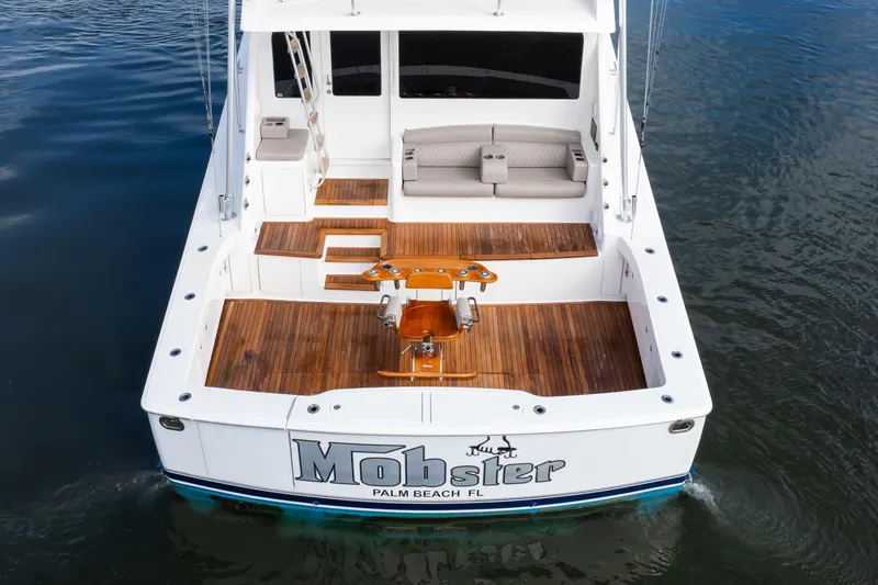 Slide: The Image of 2007 Viking 68 Convertible yacht with teak deck, docked in calm waters. - 28