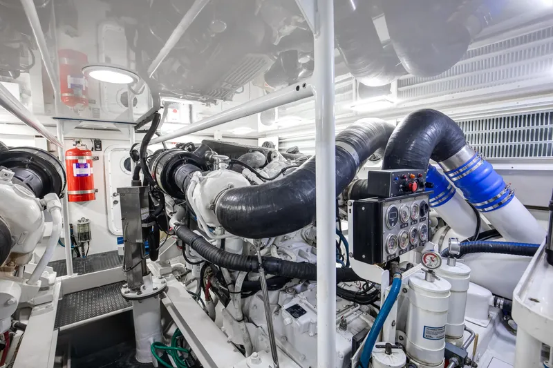 Slide: The Image of Engine room of 2007 Viking 68 Convertible yacht, featuring complex machinery and gauges. - 32