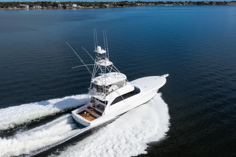 Slide: The Image of 2007 Viking 68 Convertible yacht cruising on open water, creating a dynamic wake. - 33