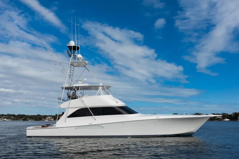 Slide: The Image of 2007 Viking 68 Convertible yacht on calm water under blue sky. - 36