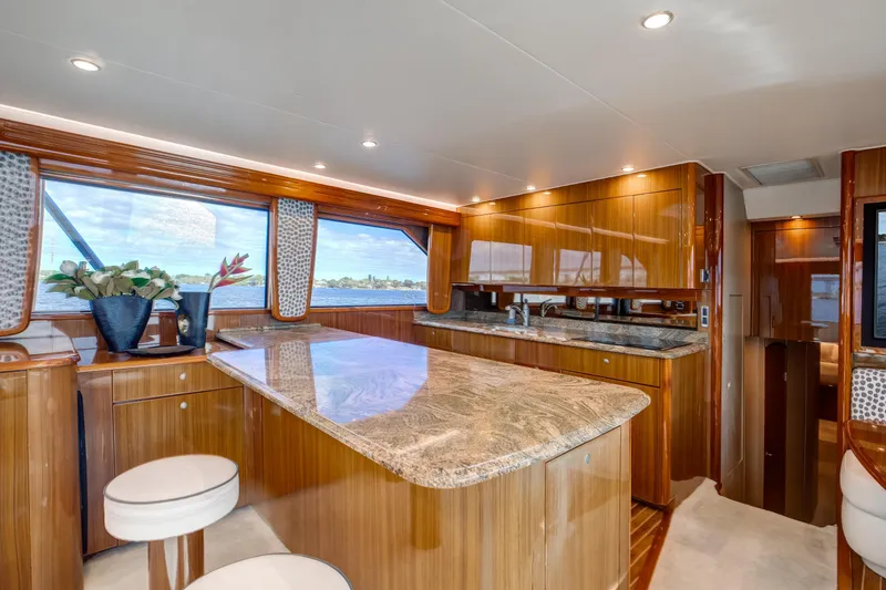 Slide: The Image of Luxurious interior of 2007 Viking 68 Convertible yacht with elegant wood finishes and granite countertops. - 6
