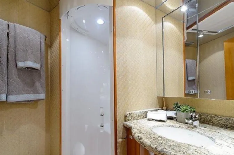 Slide: The Image of Luxurious bathroom in 2007 Hatteras 68 Convertible yacht with granite countertop and modern shower. - 10