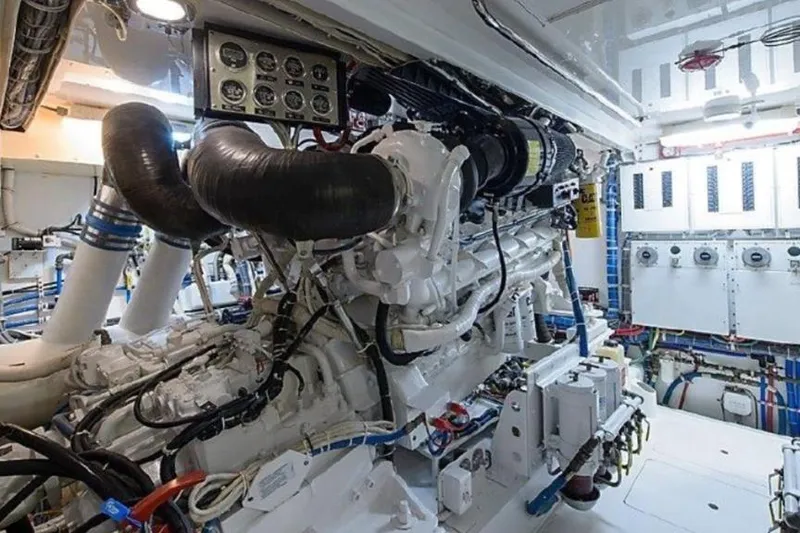 Slide: The Image of Engine room of 2007 Hatteras 68 Convertible yacht, showcasing complex machinery and controls. - 14