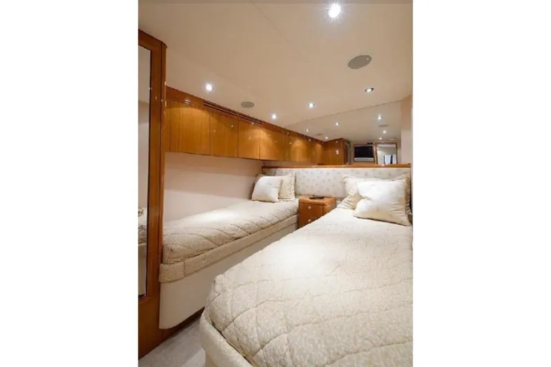 Slide: The Image of Luxurious cabin interior of 2007 Hatteras 68 Convertible yacht with twin beds and wood finish. - 15