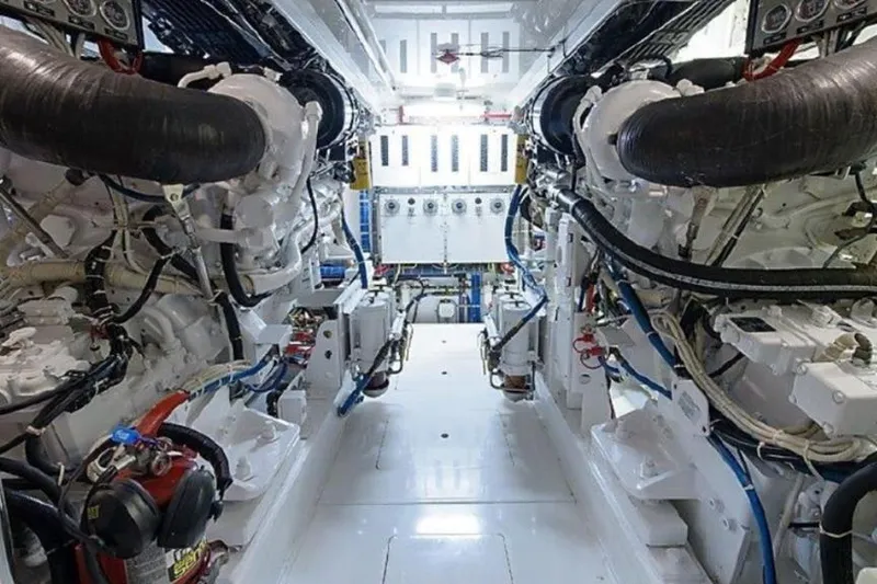 Slide: The Image of Engine room of 2007 Hatteras 68 Convertible yacht, showcasing dual engines and mechanical systems. - 16