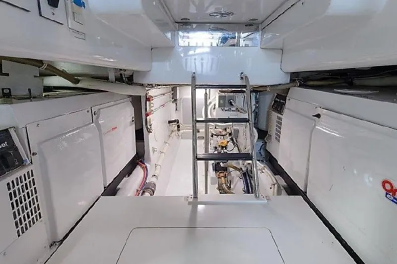 Slide: The Image of Engine room of 2007 Hatteras 68 Convertible yacht, featuring clean, organized equipment layout. - 18