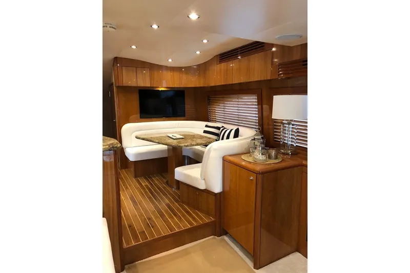 Slide: The Image of Luxurious interior of 2007 Hatteras 68 Convertible yacht with elegant wood finishes and cozy seating. - 19
