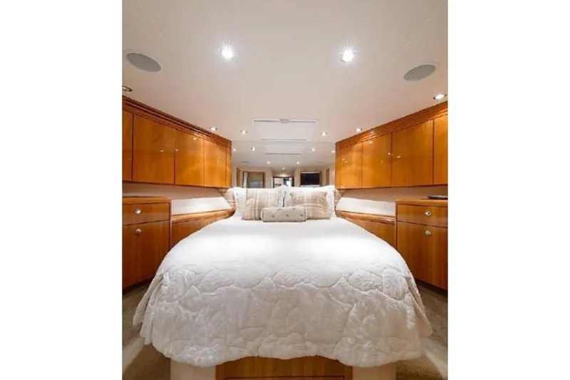 Slide: The Image of Luxurious bedroom interior of 2007 Hatteras 68 Convertible yacht with elegant wood cabinetry. - 2