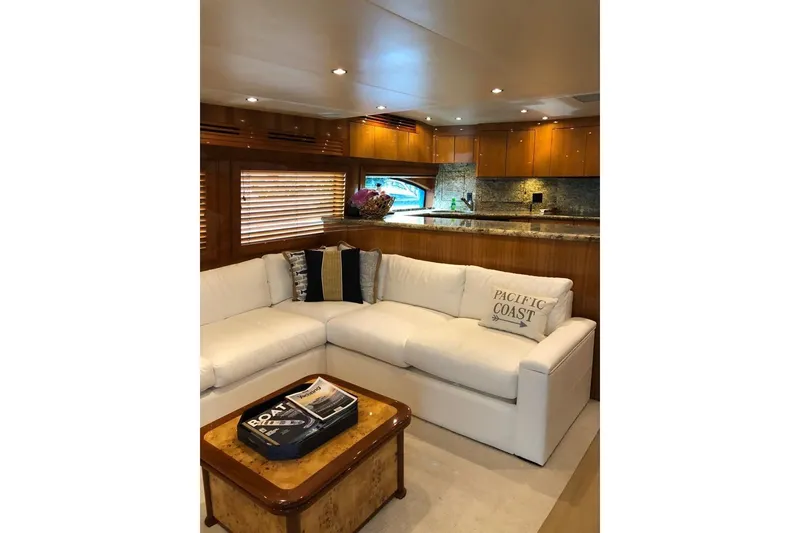 Slide: The Image of Luxurious interior of 2007 Hatteras 68 Convertible yacht with white sofa and wooden accents. - 20