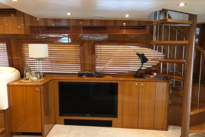 Slide: The Image of Luxurious interior of 2007 Hatteras 68 Convertible yacht with wooden cabinetry and spiral staircase. - 21