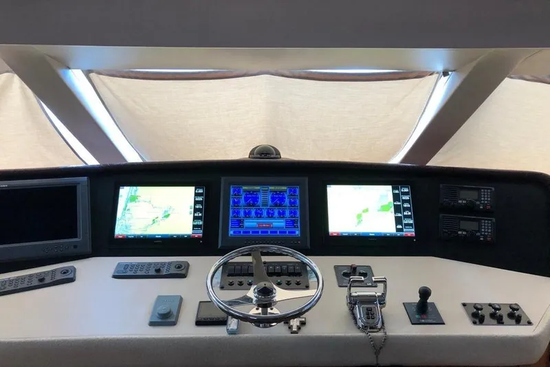 Slide: The Image of Helm of 2007 Hatteras 68 Convertible yacht with navigation screens and controls. - 24