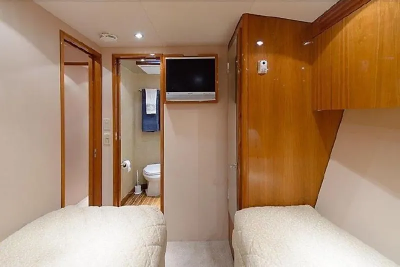 Slide: The Image of Interior of 2007 Hatteras 68 Convertible yacht with twin beds and bathroom. - 3
