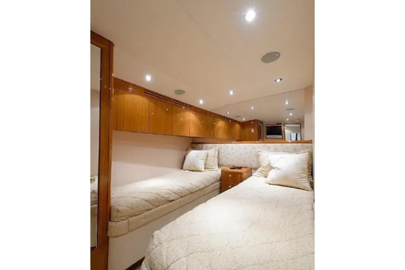 Slide: The Image of Luxurious cabin interior of 2007 Hatteras 68 Convertible yacht with twin beds and wood cabinetry. - 6