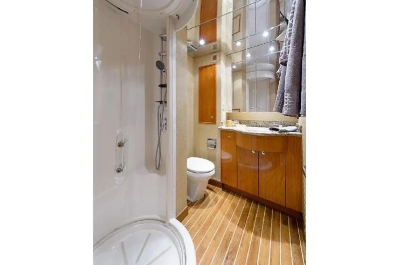 Slide: The Image of Luxurious bathroom in 2007 Hatteras 68 Convertible yacht with shower and wooden cabinetry. - 7