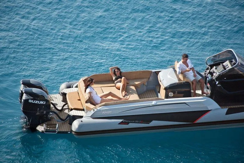Slide: The Image of 2026 Ranieri CAYMAN 38.0 EXECUTIVE boat with people relaxing on deck in clear blue water. - 4