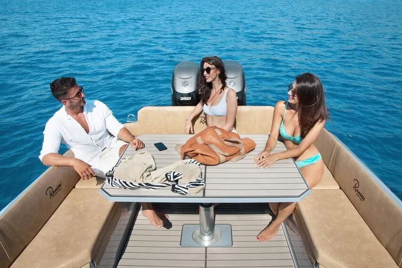 Slide: The Image of People relaxing on a 2026 Ranieri CAYMAN 38.0 EXECUTIVE boat in clear blue waters. - 9