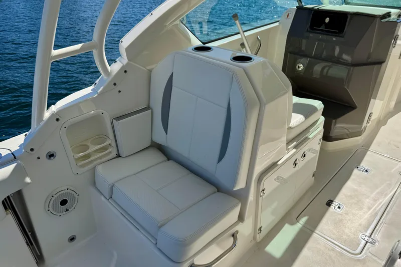 Slide: The Image of 2020 Pursuit DC 266 Dual Console boat interior with seating and cup holders. - 12