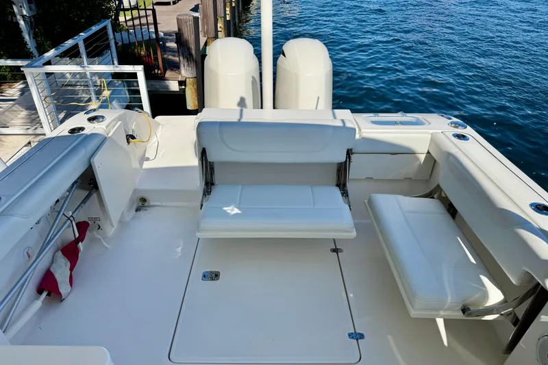 Slide: The Image of 2020 Pursuit DC 266 Dual Console boat interior with white seating and ocean view. - 13