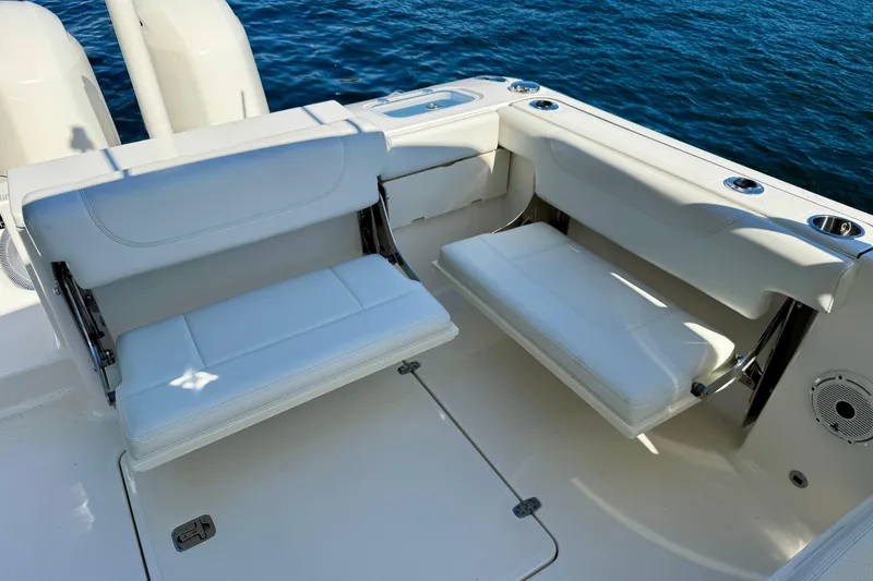Slide: The Image of 2020 Pursuit DC 266 Dual Console boat with white seating, on calm blue water. - 15