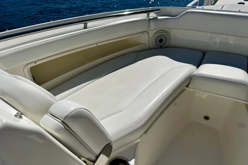Slide: The Image of Luxurious seating on 2020 Pursuit DC 266 Dual Console boat with ocean backdrop. - 17
