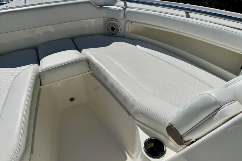 Slide: The Image of 2020 Pursuit DC 266 Dual Console boat interior with cushioned seating and cup holder. - 18