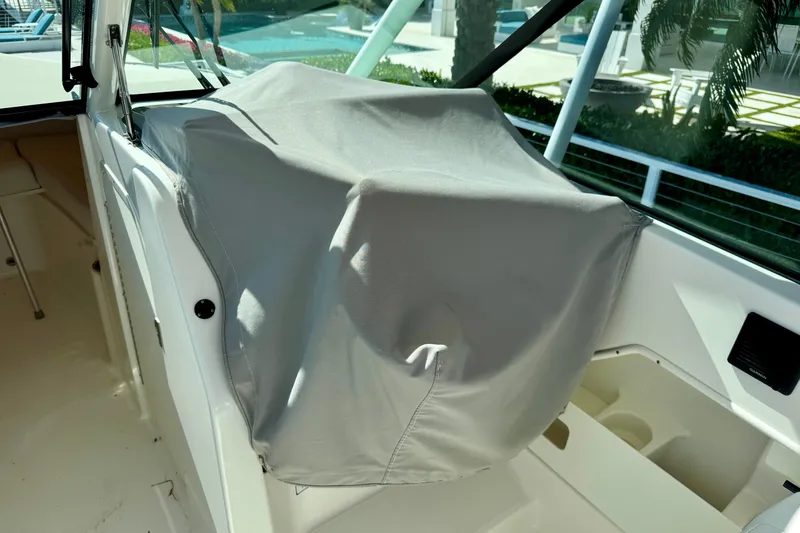 Slide: The Image of 2020 Pursuit DC 266 Dual Console boat interior with covered dashboard. - 21