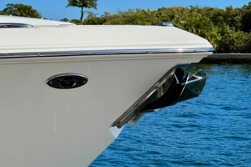 Slide: The Image of 2020 Pursuit DC 266 Dual Console boat bow with anchor, on blue water background. - 24