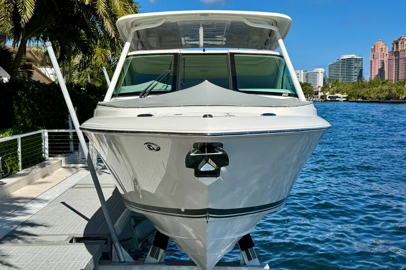 Slide: The Image of 2020 Pursuit DC 266 Dual Console boat docked by waterfront. - 5